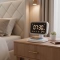 Smart digital alarm clock with LED display and wireless charging pad on UAE bedroom nightstand