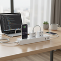 Smart WiFi power strip with UAE Type G sockets and USB ports on clean home office desk